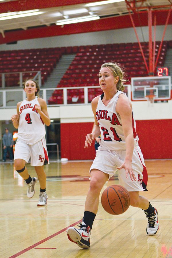Junior Emily Drews moves the ball up the floor during a game in Chase Gymnasium. Biola lost to California Baptist, and then upset Azusa Pacific to bring their conference record to 2-1 for the season. Job Ang/ The Chimes