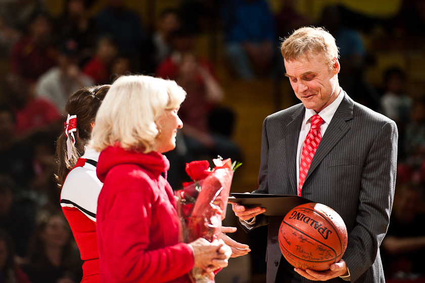 Coach Holmquist receives a plaque and basketball signed by current and past Biola players at a ceremony celebrating his 800 career wins as a coach, a feat matched by only 15 other college coaches. |Mike Villa/THE CHIMES
