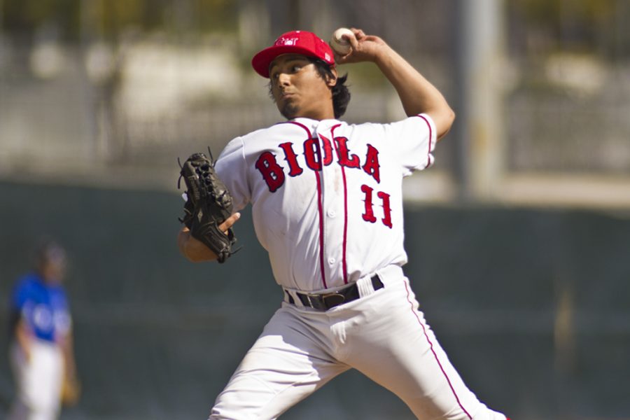 Junior Nate Coronado delivers a pitch en route to Biolas 8-4 win in the first game of a double-header against Arizona Christian on Thursday, February 17. | Job Ang/THE CHIMES