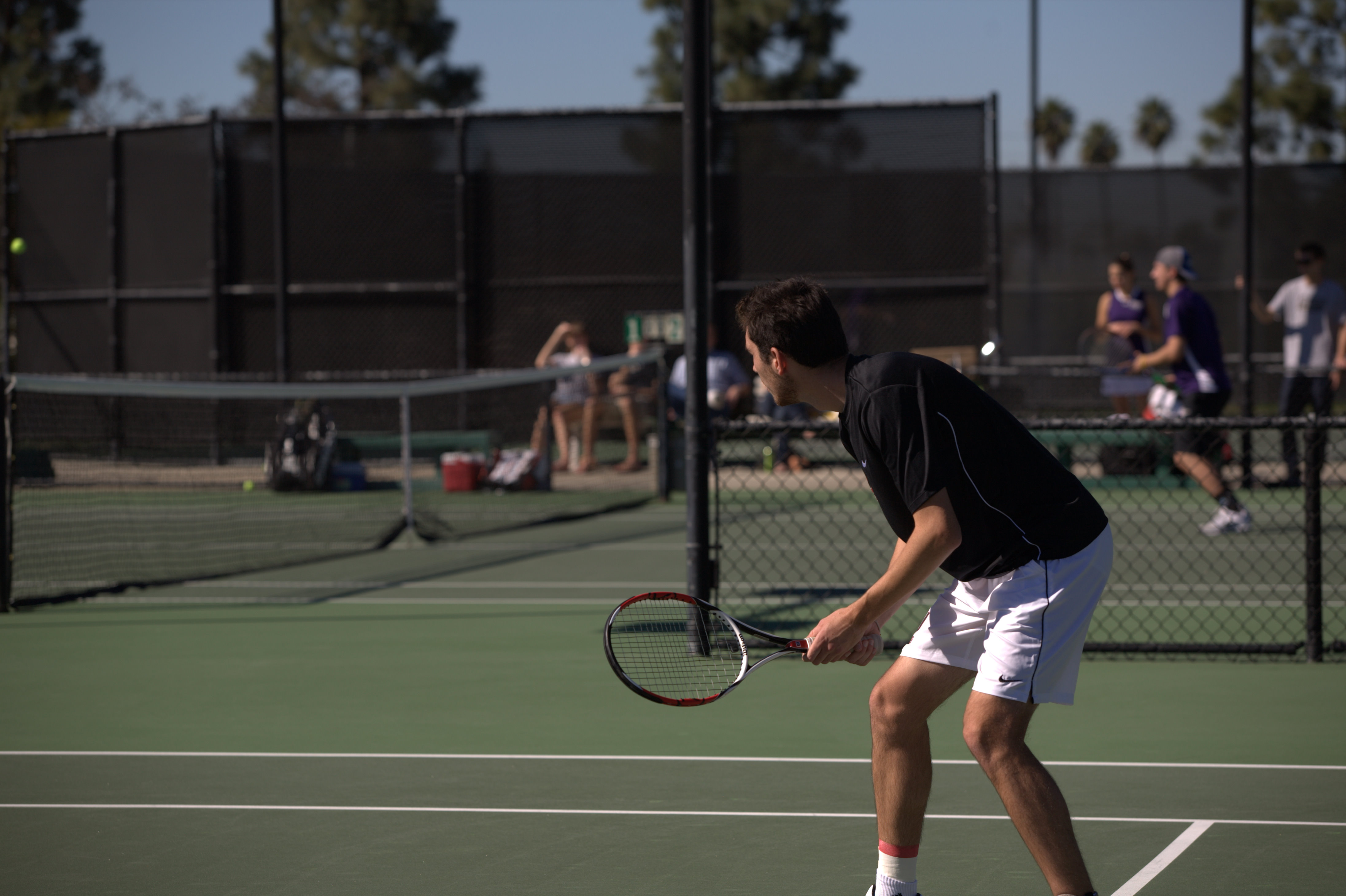 Senior Ryan Adams waits for the ball in Biola's home match against the Whittier College Poets Feb. 12. ADAM LORONA/The Chimes