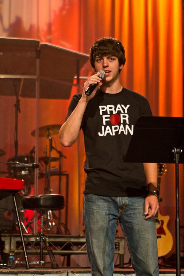 Freshman Matthew Little talks about the Pray For Japan t-shirts that are being sold to aid in Japan relief efforts during Session Five of Missions Conference Thursday, March 17, 2011. | Job Ang/THE CHIMES