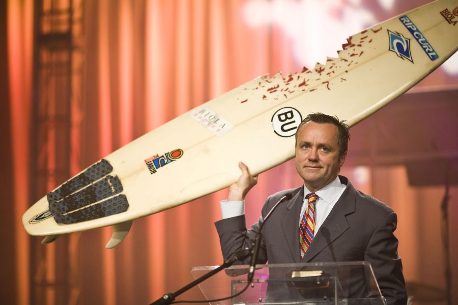 President Corey uses a surfboard to speak to students the importance of attending Missions Conference, an annual tradition for the beginning of the weeks conference. | Kelsey Heng/THE CHIMES