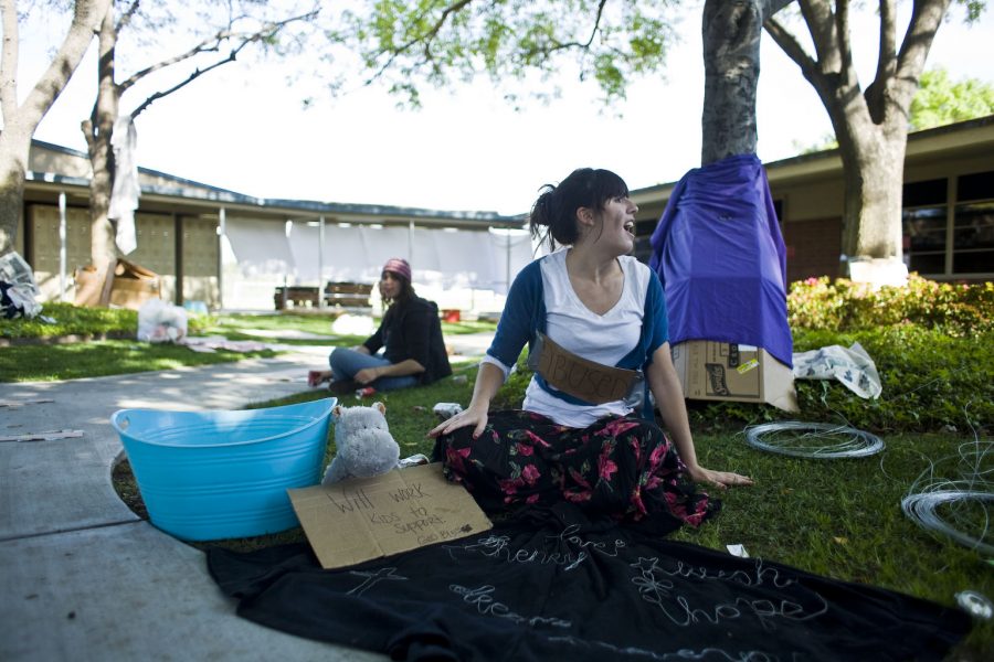Freshman Hannah Caprara shouts to students passing by within the homeless community, one of the new additions to Global Awareness this year. | Kelsey Heng/THE CHIMES