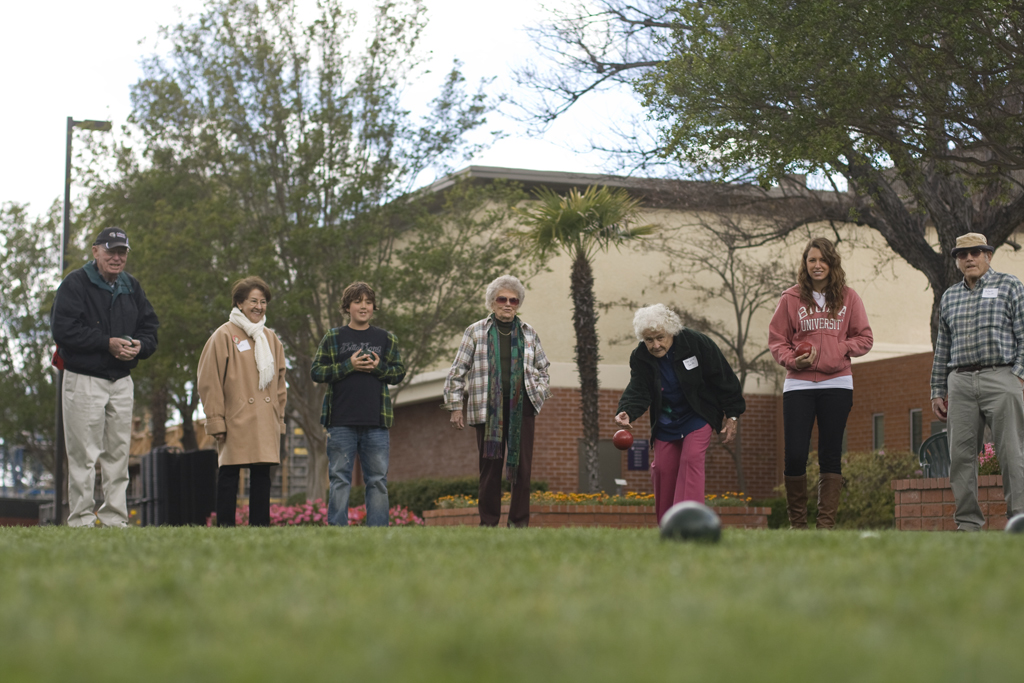 Margerite and Robert Smith play bocce ball with granddaughter, senior April Smith, and Jerry and JoAnn Raemakers with their grandson, brother to sophmore Cody Raemakers. | Katie Juranek/THE CHIMES