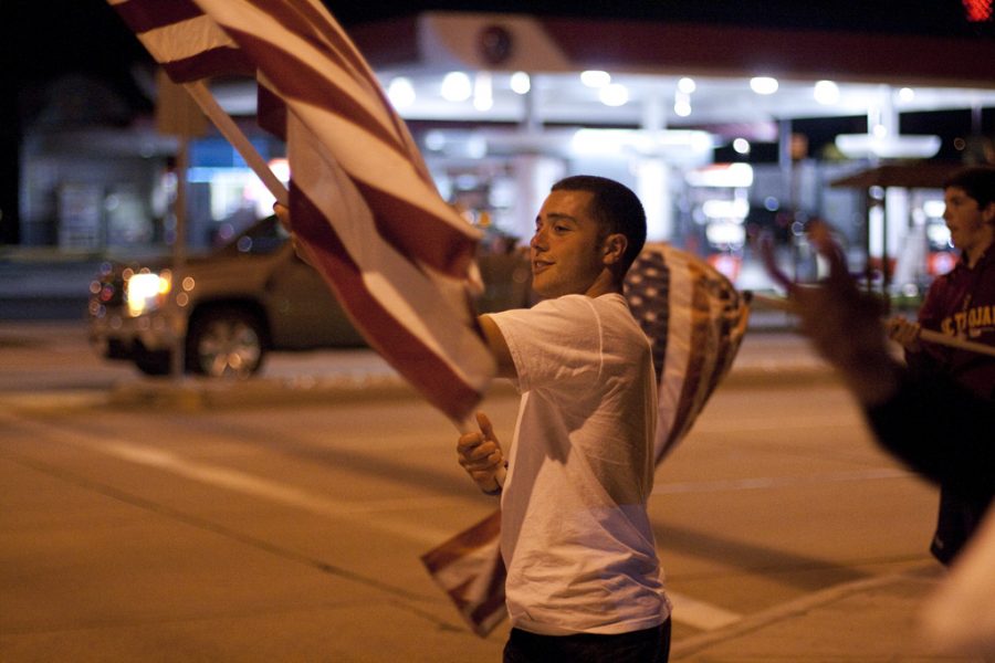 Miles Aiello stood on the corner of Imperial and La Mirada Sunday night, May 1, 2011, to proclaim Americas victory in the war against terrorism with a few friends, waving flags and getting cars to honk in response. | Katie Juranek/THE CHIMES
