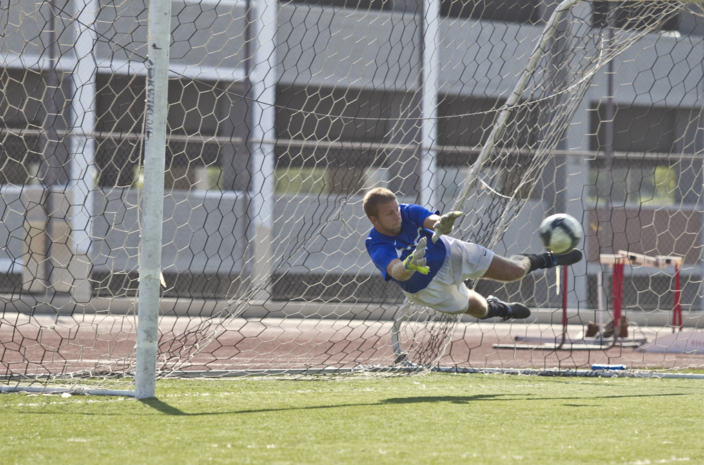 Aaron Fenlason dives to make a save at the September 17, 2011 game. Biola tied with Menlo at 1-1. | Tyler Otte/THE CHIMES