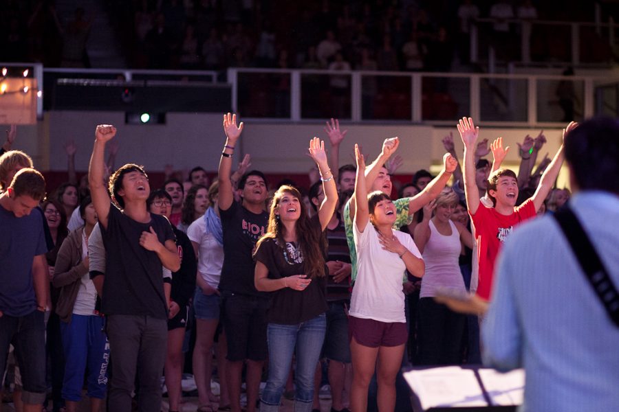 Students lift their hands and sing in worship during the final song of a special 9/11 Singspiration service on Sunday night, September 11, 2011. | Job Ang/THE CHIMES