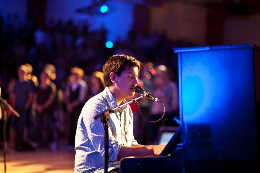 Singer Alan Garcia plays the piano as he leads the Biola student body in worship during a special 9/11 memorial Singspiration service on Sunday night. | Job Ang/THE CHIMES