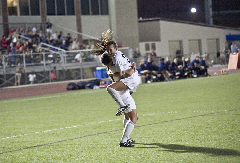 Junior midfielder Katie Cabuling celebrates with senior forward Brittany Barr, after Cabuling scored Biola's first goal of the match on Tuesday, September 20, 2011. Biola won 3-0.| Job Ang/THE CHIMES