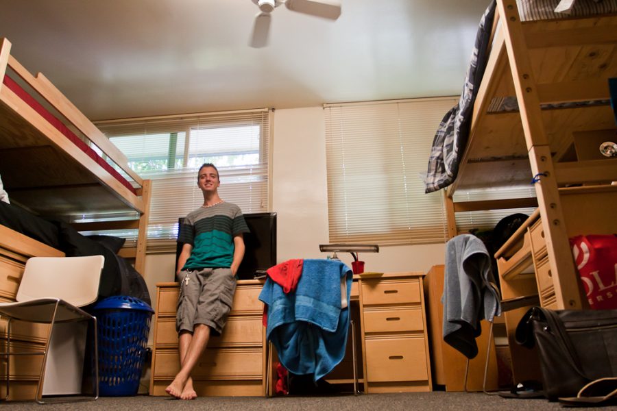 Freshman Daniel DiRisio stands in his tripled dorm room in Emerson Hall. The influx of freshmen this year has increased the number triples on campus. | Tyler Otte/THE CHIMES