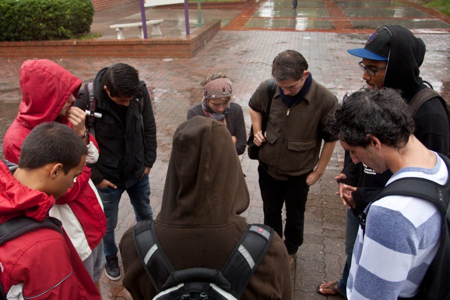 Devoted students stand in the rain to pray during one of the five meeting times for Prayer at the Belltower on October 5, 2011. | Tyler Otte/THE CHIMES