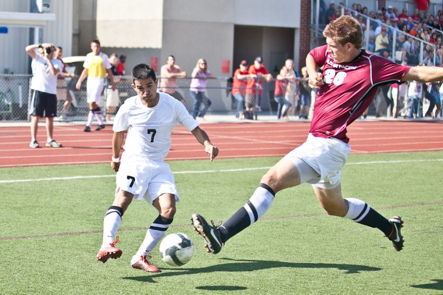 Freshman Eric Sotelo fights to keep the ball away from an APU Cougar during the mens game on Saturday, October 15, 2011. | Job Ang/THE CHIMES