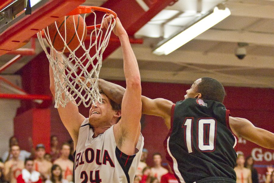 Senior Davey Hopkins dunks against APU for one of the most memorable moments of the night. Biola beat APU on Jan. 31 with a final score of 65-58. | Tyler Otte/THE CHIMES
