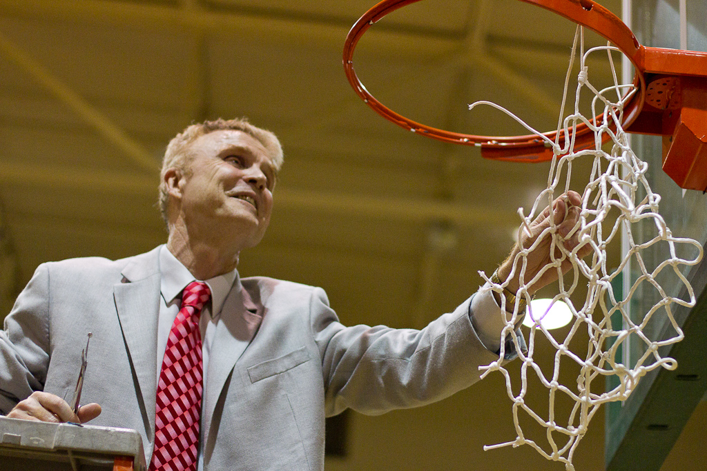 Men's basketball coach, David Holmquist, cuts down the basketball net at Concordia University in celebration of the winning the GSAC Tournament Championship on March 6, 2012. The Biola Eagles beat the Concordia Eagles with a final score of 81-77. | Tyler Otte // THE CHIMES [file]