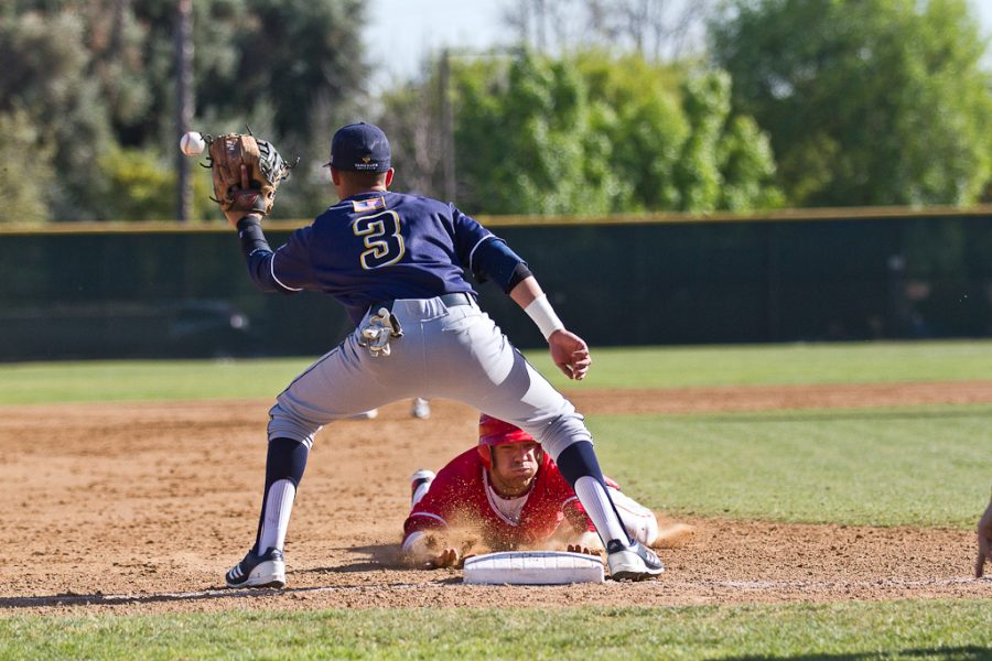 Senior Vinnie Fayard slides to safety at the March 8, 2012 games against Azusa Pacific. Biola won 8-2. | Tyler Otte/THE CHIMES