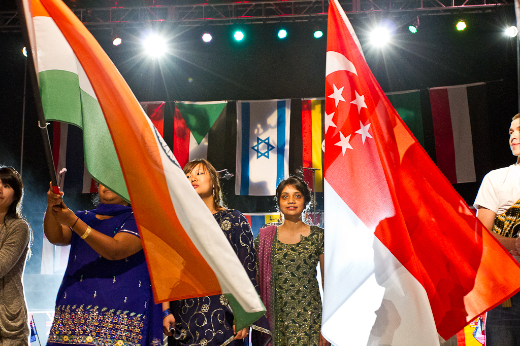 From left to right, Esther Perumalla, Sani Putsure, and Jacinth Musuku represent India during the Parade of Flags at the first Missions Conference session on March 14, 2012, by waving the flag and wearing traditional Indian clothing. | Adam Lorona/THE CHIMES