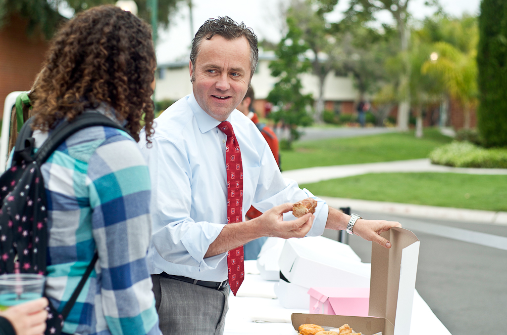 Dr. Barry Corey enjoys a donut while conversing with a student during the Donuts With DBC event that took place on Wednesday evening, May 2, 2012. The event was held in the fireplace pavilion, where campus leaders such as Dr. Corey met on a panel to discuss campus concerns and issues via questions that were raised by students. | Deborah Lee/THE CHIMES