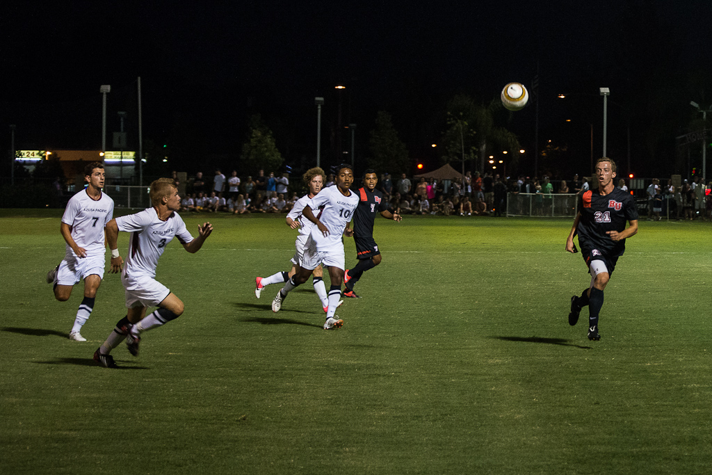 Senior Tony Montalvo (left) and junior Scott Hayes (right) chase down the ball in Saturday night's game against Azusa Pacific University. | Olivia Blinn/THE CHIMES