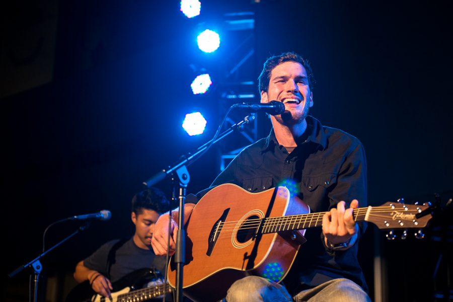 Opening for Josh Garrels, senior Carson Leith performs an original for the giant crowd. | Olivia Blinn/THE CHIMES
