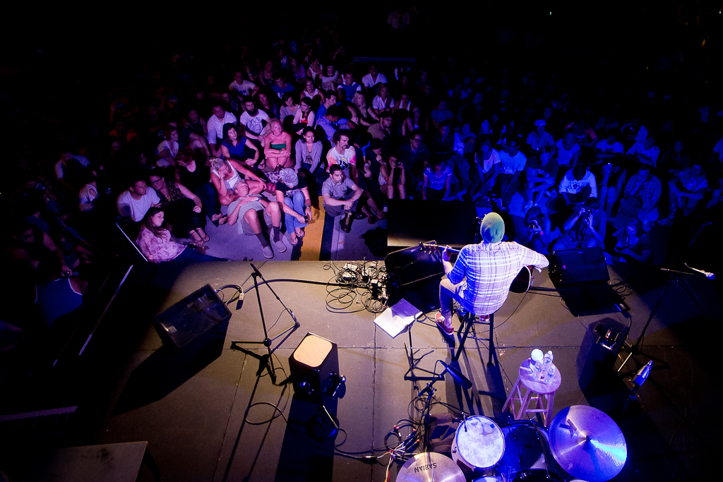 Looking out upon a sea of over 1,000 faces, Josh Garrels plays for a captivated crowd at the Eddy. | Emily Arnold/THE CHIMES