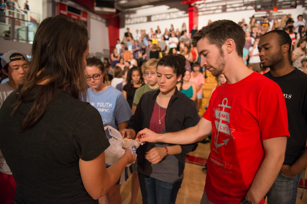 Senior Mackenzie Burns shares in communion during chapel on Wednesday morning. Every semester, students are invited to “go to the table” in chapel during the campus-wide Day of Prayer. | Olivia Blinn/THE CHIMES