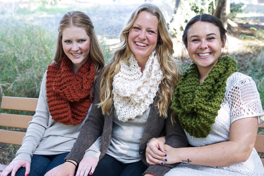 Sophomores Paige Dinneny, Haily Morrell and Hannah Efron cozy up wearing infinity scarves knit by club members. | Courtesy of Jaicee Almond