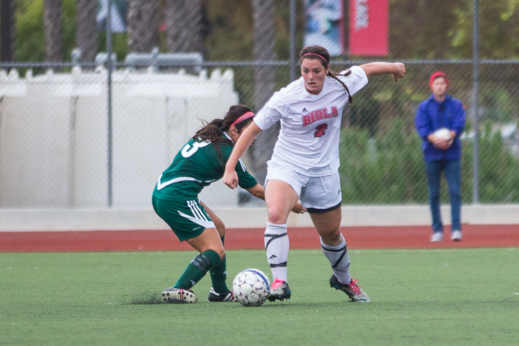 Junior Michelle Andre pushes forward, preventing Concordia University from advancing toward the goal in Saturday's game. Grant Walter/THE CHIMES