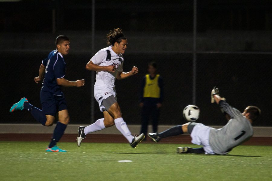 Junior Daniel Chew attacks and scores in the game against Vanguard University on Saturday night. Ashleigh Fox/THE CHIMES