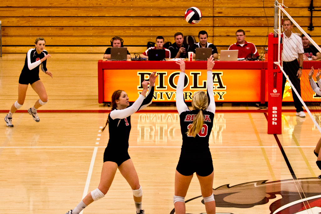 Justine Schoneveld sets up a spike for teammate Nicolette Mather against San Diego Christian College at Biola's own gym on Tuesday. | John Buchanan/THE CHIMES