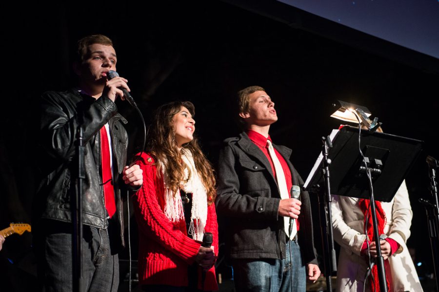 Sophomore Nick Mercer, junior Crystal Harrell, sophomore Levi Duren, and junior Tori Caplinger invite the crowd to join in singing Christmas carols. | Olivia Blinn/THE CHIMES