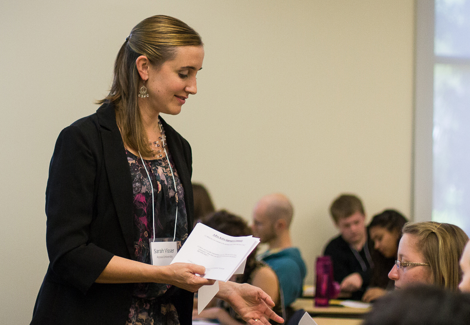 During her Saturday afternoon workshop, Sarah Visser, from Azusa Pacific University, hands out a flyer entitled "A Proactive Approach to Community" to help students discern how to put what they are learning into practice. | Emily Arnold/THE CHIMES 