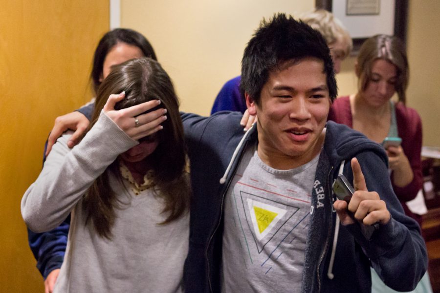 Junior Evan Tan and sophomore Becky Gallacher celebrate winning the AS presidential election by one vote with their campaign team and friends after receiving the news by phone in Hart Hall early Friday morning. | John Buchanan/THE CHIMES