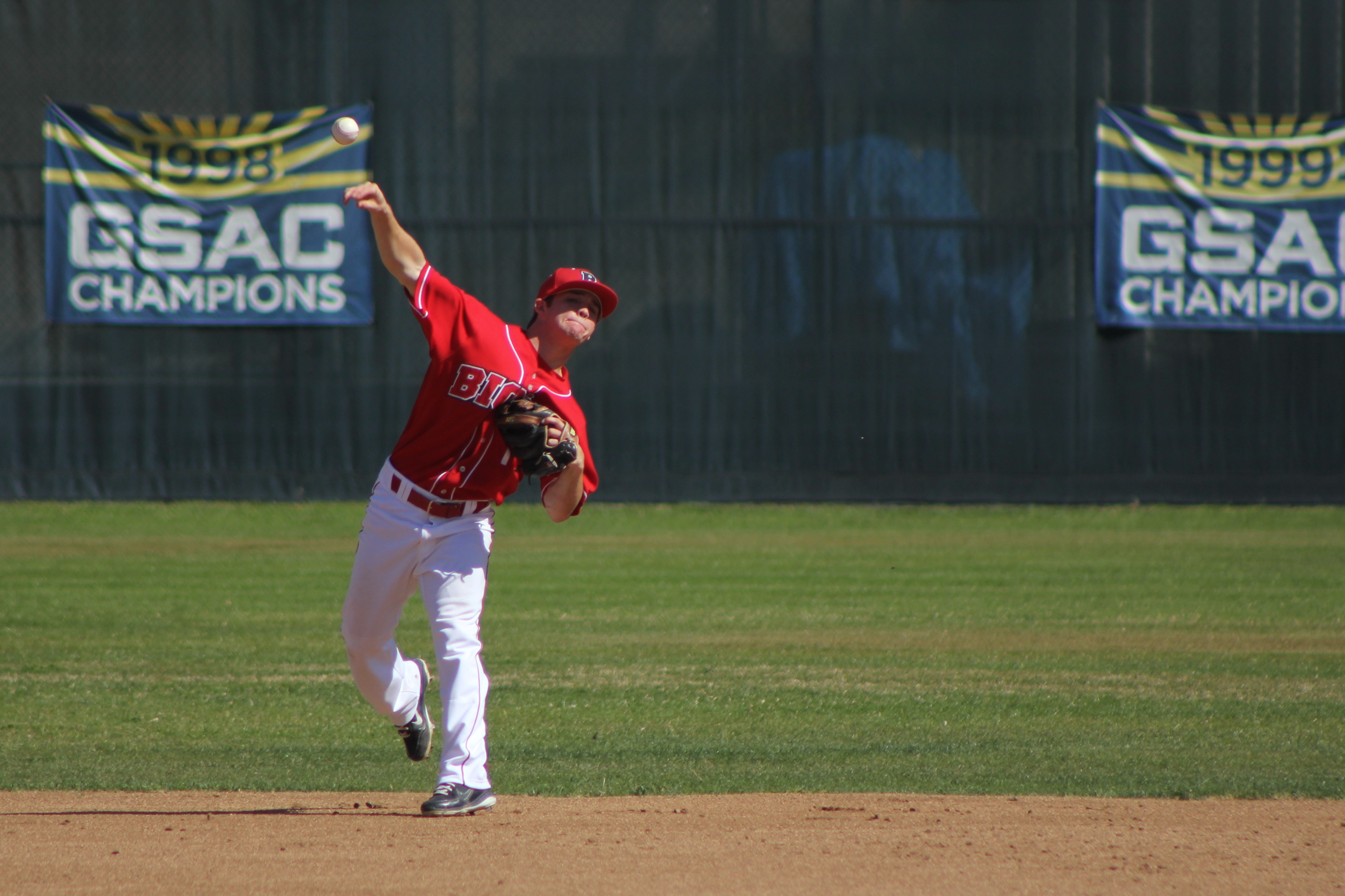 Junior shortstop Johnny Farrington makes a throw from deep short against Azusa Pacific University on February 16. | Conner Penfold/THE CHIMES