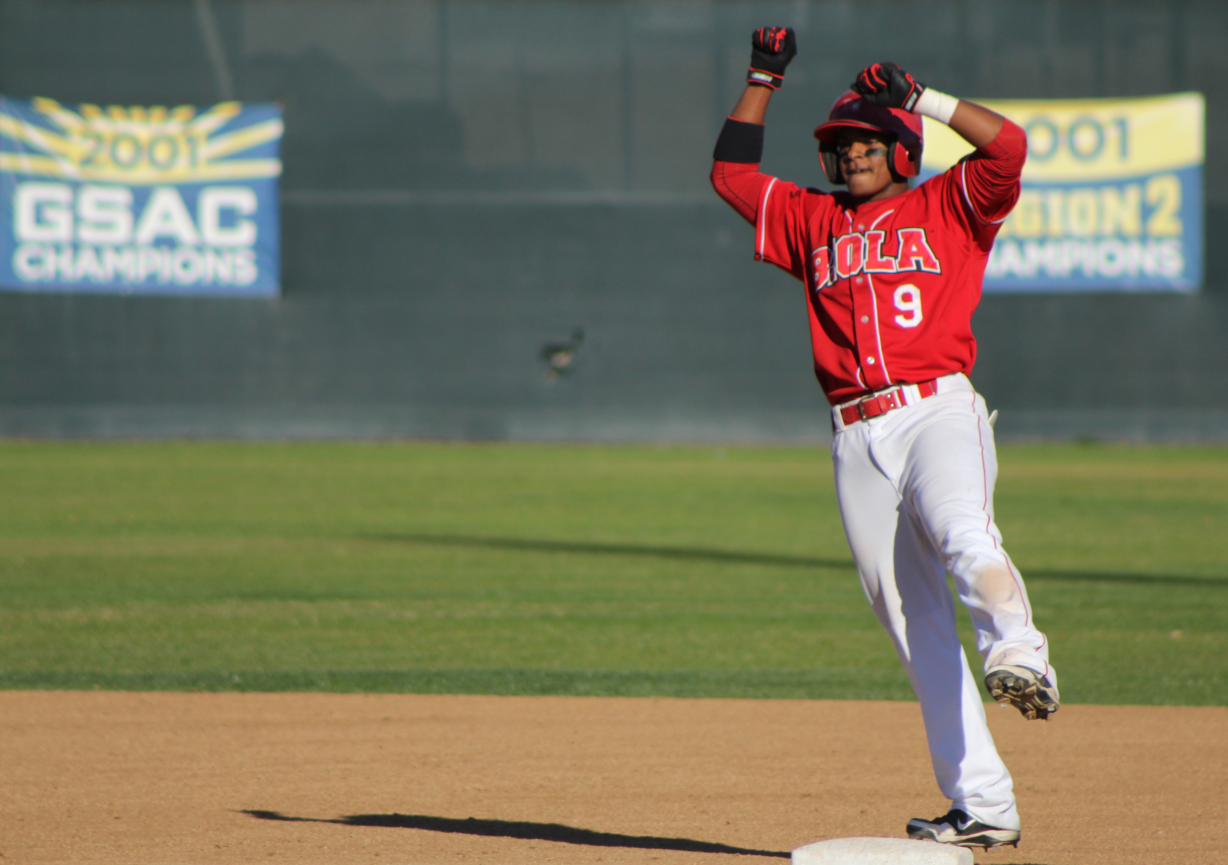 Junior right fielder Vince Lawrence motions to his teammates in the dugout after his two-out, two-run double gave Biola a 6-4 lead. | Conner Penfold/THE CHIMES