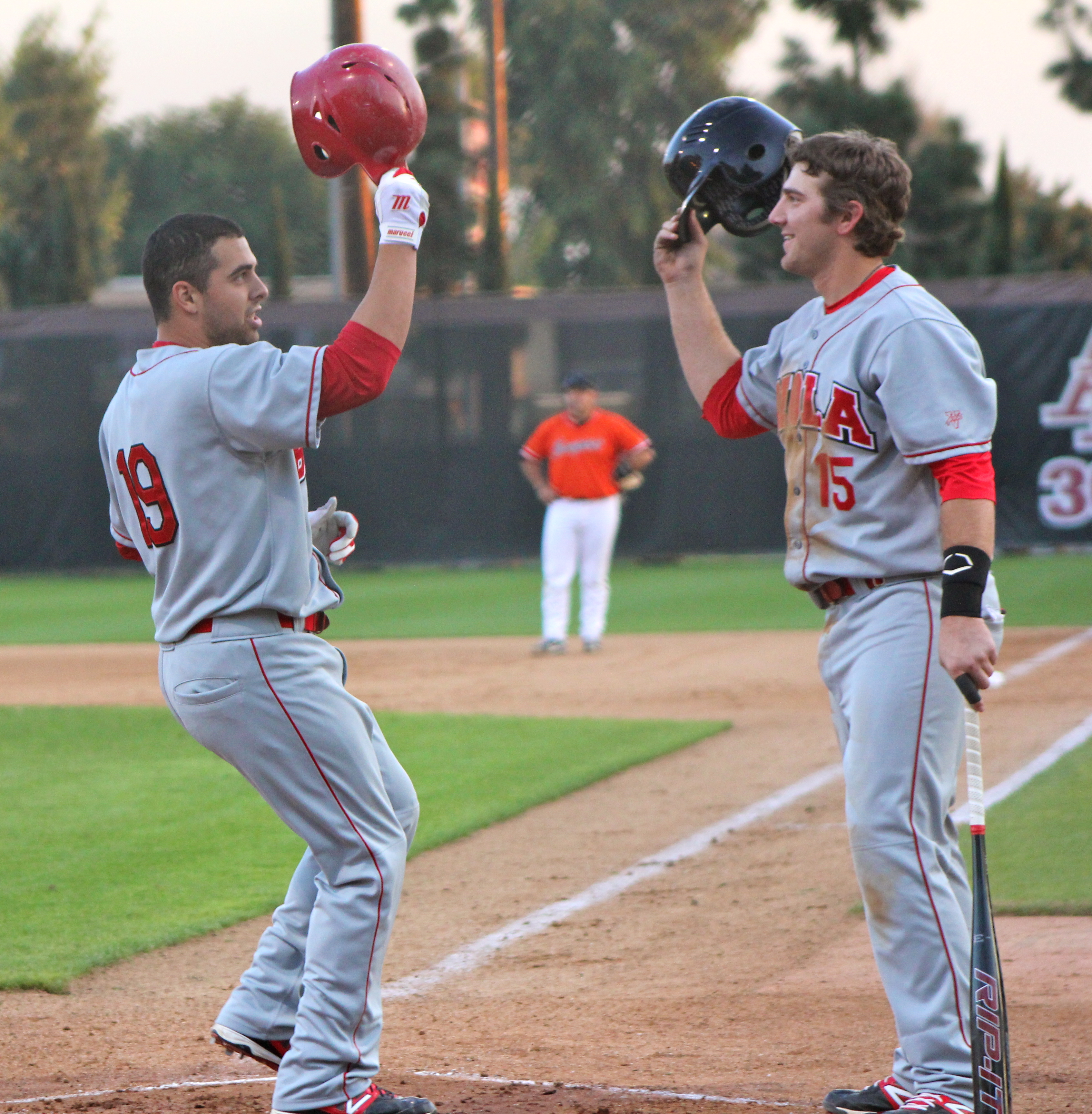 Junior second baseman Michael Annunziata (left) congratulates fellow teammate Nick Oddo (right) after launching a two-run homer in the first inning of Thursday rout of Azusa Pacific. | Conner Penfold/THE CHIMES
