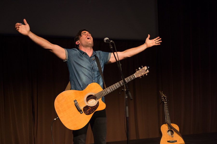 Phil Wickham takes a step back from the microphone while leading the crowd in Nothing but the Blood. | Olivia Blinn/THE CHIMES