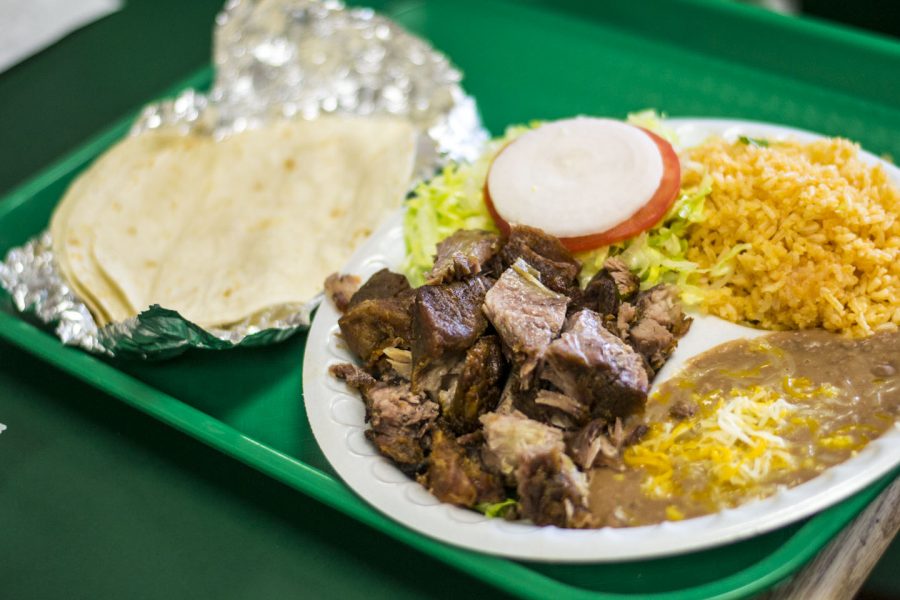 A plateful of tender carnitas is accompanied with rice, beans and lettuce to pile into fresh tortillas. For a low price at local restaurant El Camino Real, customers can receive two meals’ worth of food. | Ashleigh Fox/THE CHIMES 
