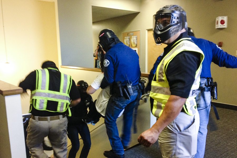 A student actor poses as a wounded victim during Campus Safety’s active shooter training on Saturday, April 27. The training seeks to better prepare for a real emergency. | Emily Joy Johnson/THE CHIMES