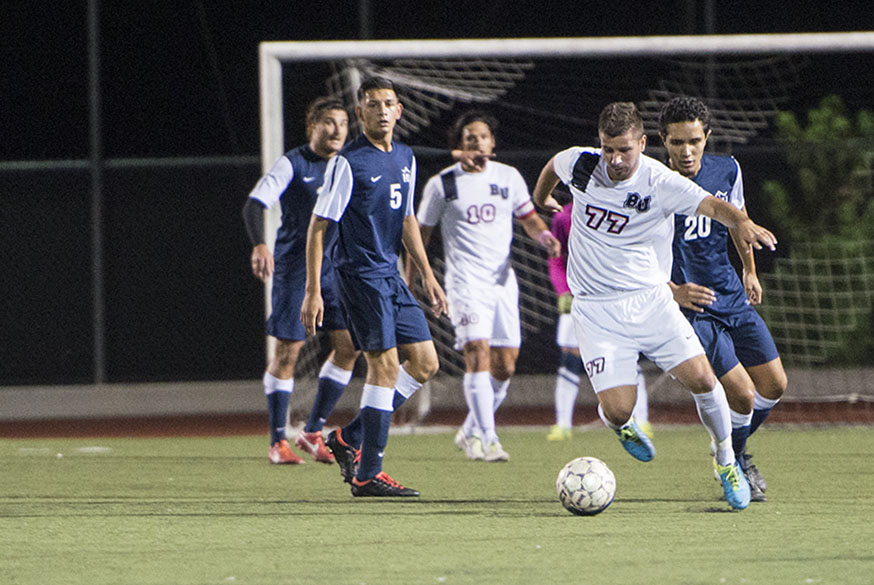 Junior midfielder Sava Pantic skims past the Hope International defense on October 23. After a lull in their season, mens soccer is back on track, winning two games in a row. | Kalli Thommen/THE CHIMES
