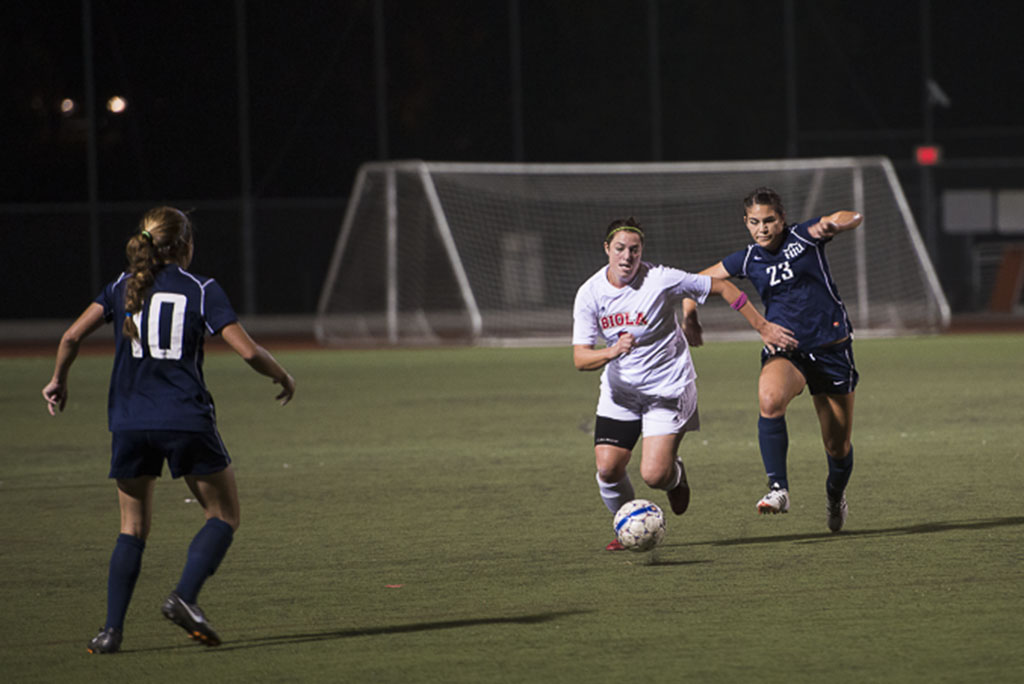 Senior defender Michelle Andre keeps one step ahead of Hope International during the game on October 23. This was the trend throughout the evening, with Biola ending up on top, scoring 3 goals to Hope International's empty scoreboard. | Natalie Lockard/THE CHIMES