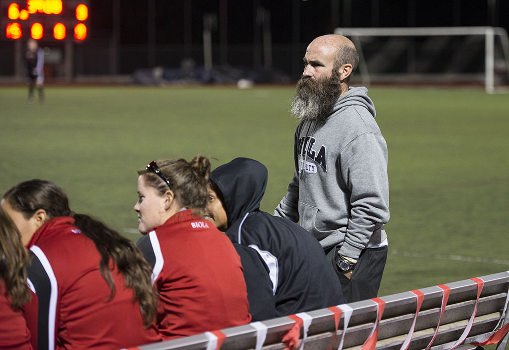 Coach Todd Elkins stands patiently on the sideline as his women's soccer team battles Arizona Christian on October 29. Elkins coaches both men and women's teams for Biola. | Natalie Lockard/THE CHIMES