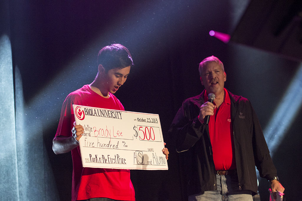 Sophomore Brady Lee marvels at his $500 prize for winning first place with his evangelism magic act. | Ashleigh Fox/THE CHIMES