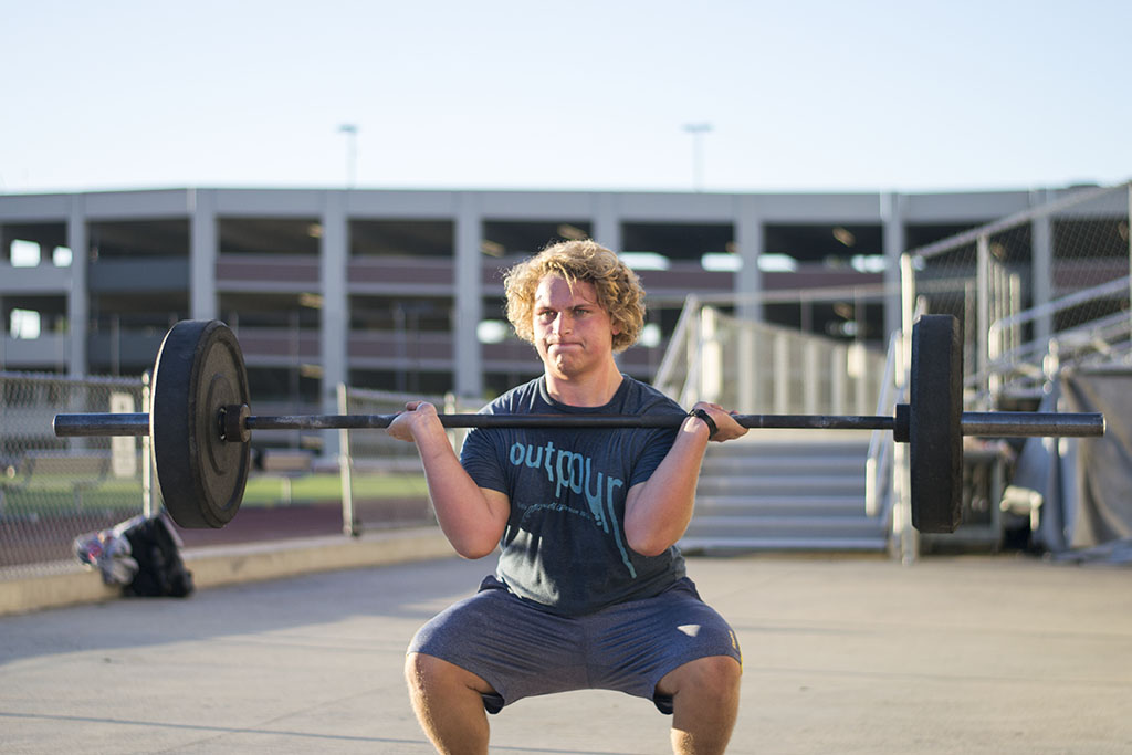 Grossman works his way through a clean during CrossFit Biola. Even with a bulging disc in his back, Grossman fights through the pain, but makes sure to stay in tune to his body, not wanting to hurt himself further. | Ashleigh Fox/THE CHIMES