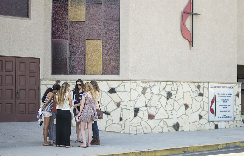 Students gather in front of the United Methodist Church next to Little India in Artesia to pray for churches in India during the Little India Prayer Walk on Friday afternoon. | Ashleigh Fox/THE CHIMES