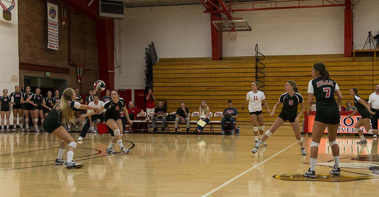 Junior Jaci Schork looks on as sophomore Crissy Cunningham passes it up to the front row. The volleyball team continues to uphold their undefeated title for the 2013 season. | Katie Evensen/THE CHIMES