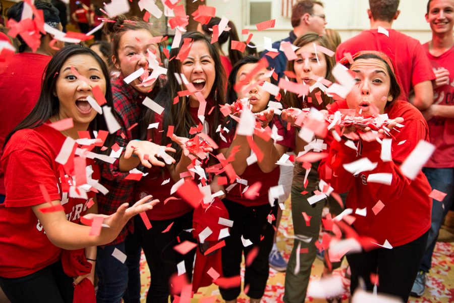 Juniors Lauren Lee, Robyn Nakamura, Ashley Panko, Diana Lam, Hope Gregory and Kylie Kitabjian blow bits of confetti into the air to celebrate the beginning of the winter sports season. | Olivia Blinn/THE CHIMES