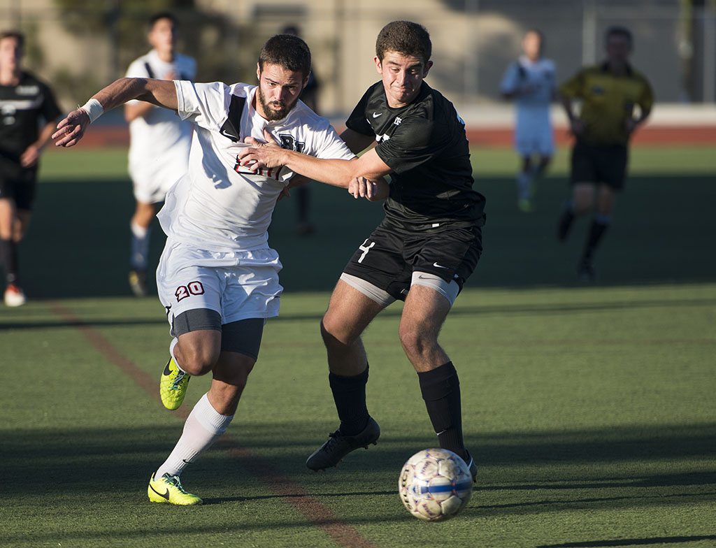 Sophomore forward Stephen Tanquary struggles out of the grips of a Westmont defender during their game on November 9. Biola defeated Westmont, earning a victory with a final score of 2-1. The men advance to the GSAC championship, facing Concordia on November 16. | Olivia Blinn/THE CHIMES