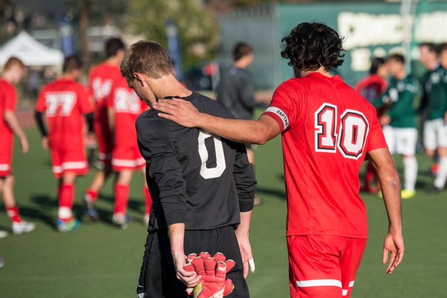 Senior forward Daniel Chew walks alongside junior goalkeeper Paul Elias after Biolas loss against Concordia on Nov. 16 in Irvine. The final score was 3-2, with even more disappointing news on Sunday when the team got word that they were not advancing to nationals. | Heather Leith/THE CHIMES
