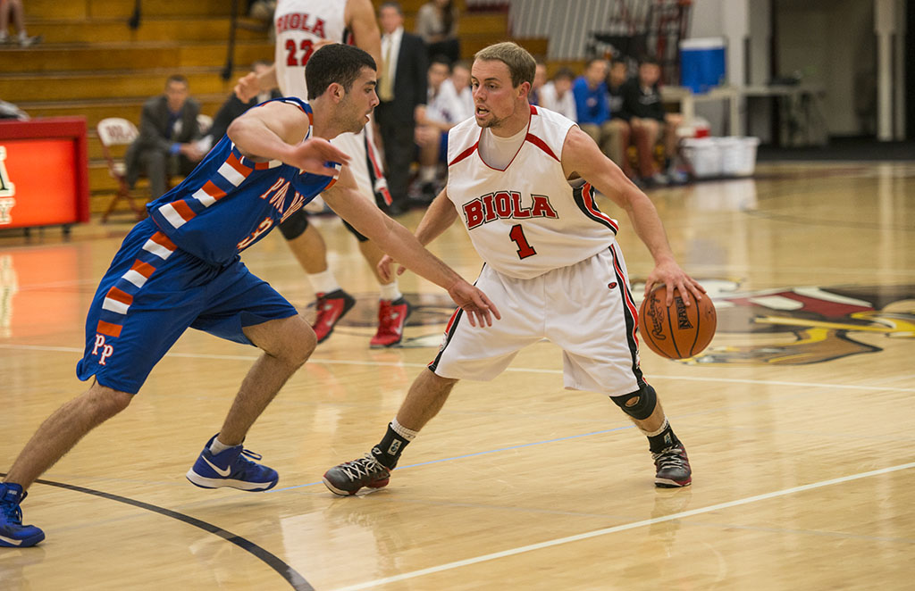 Junior guard Pierre Zook dribbles into the Pomona College defense during the game on Nov. 19. Men's basketball defeated Pomona-Pitzer 73-70, with Zook leading the team in points, scoring 19 during the course of the evening. | Kalli Thommen/THE CHIMES