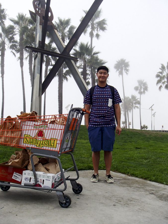 Senior David Lin stands next to the shopping cart full of brown bag meals for the homeless of Venice Beach, the new location brown bag is ministering to this year. | Courtesy of Jonathan Maestas